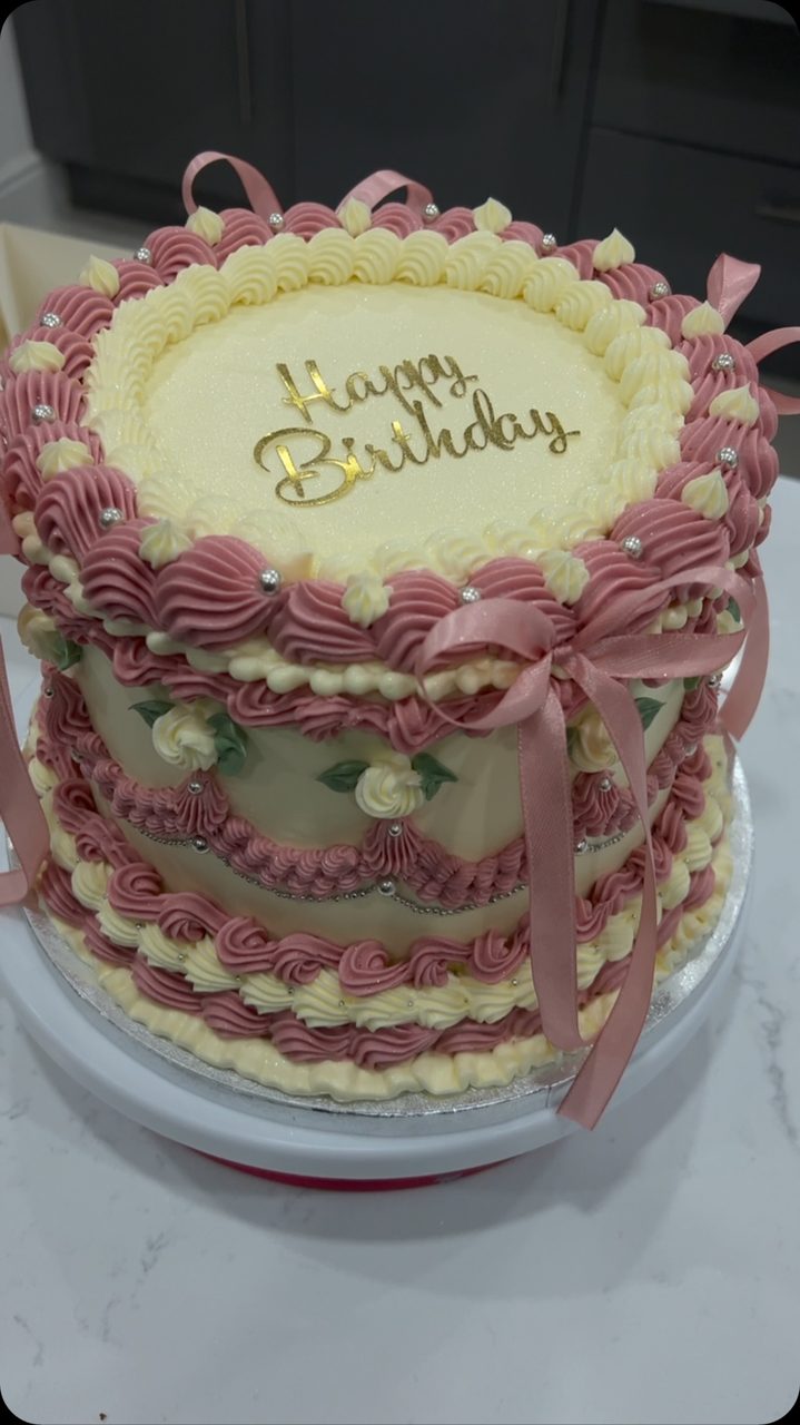 Vintage lambeth birthday cake with pink bows by Madhia's Bakery